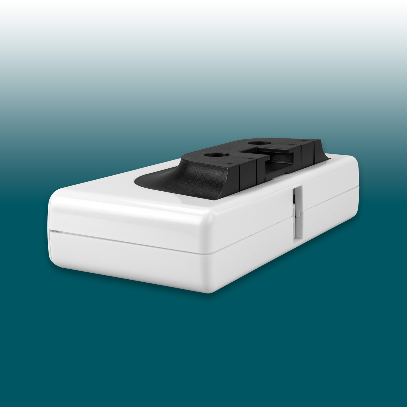 White, rectangular Desk2Device USB charger with rounded edges. Black top section featuring two round openings and a slot for mounting/connection. Narrow vertical notch on the side. USB-C and USB-A ports.
