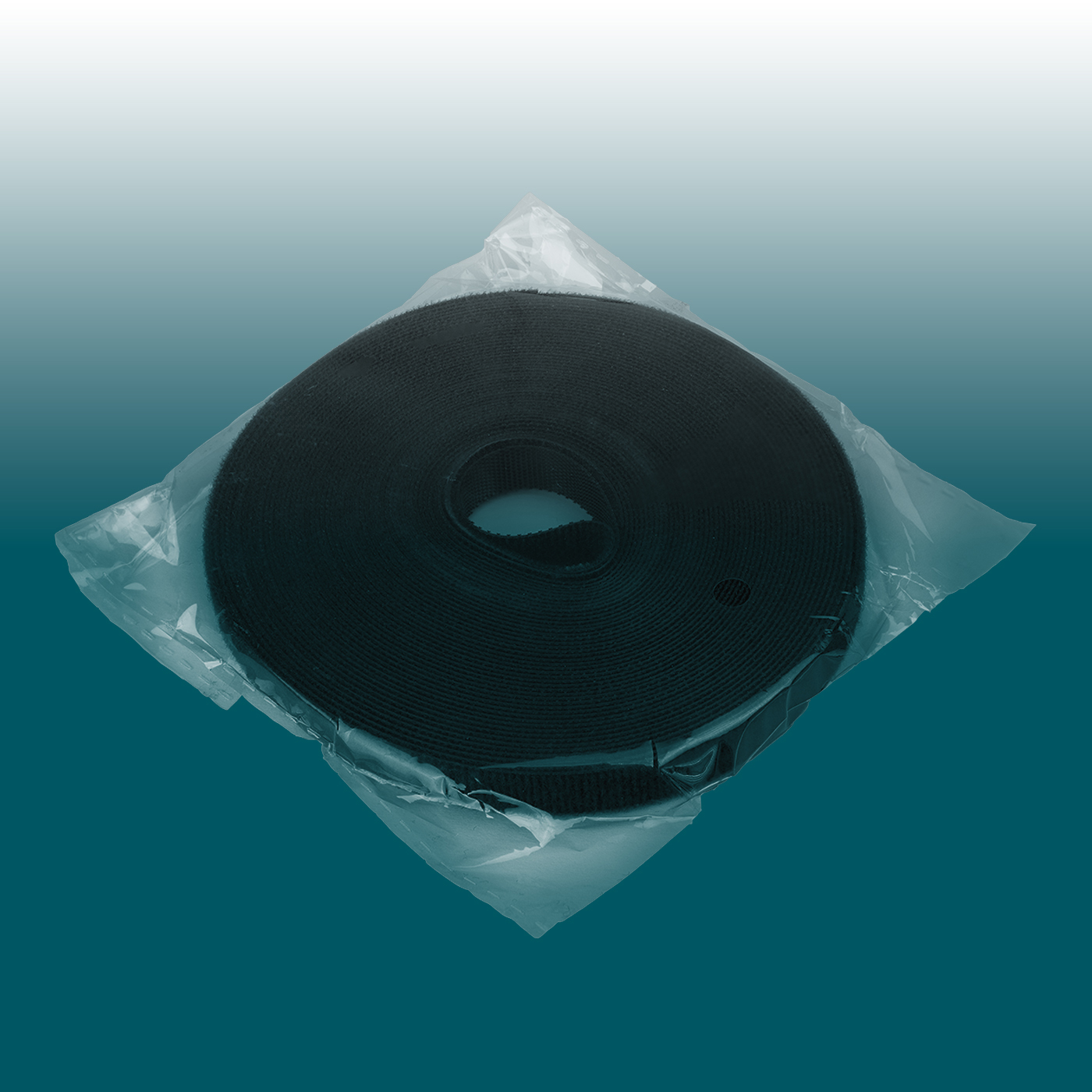 A roll of black Velcro tape, compactly wound and packaged in clear film. Versatile for bundling and organising cables, ideal for cable management. Easy to cut to size and reusable multiple times.