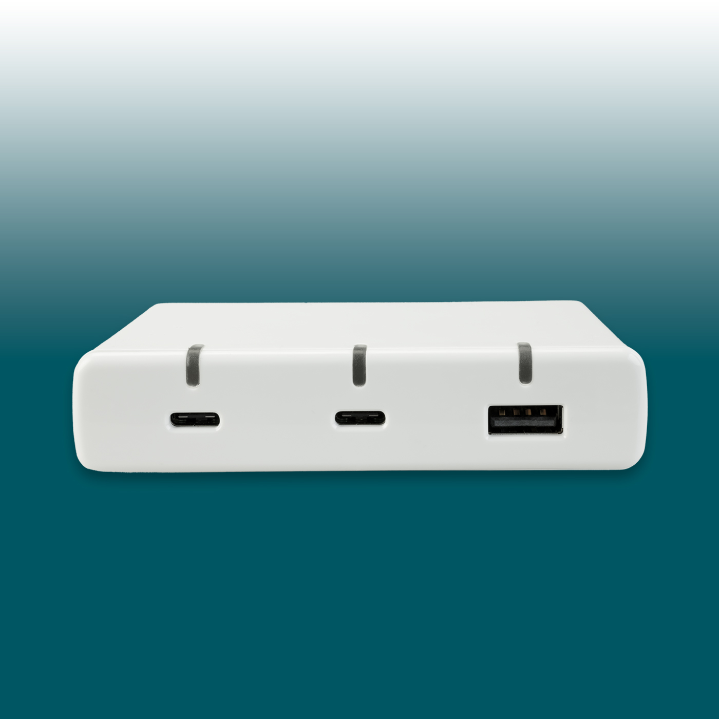 A white, rectangular USB charger with rounded corners, shown from the front. Two USB-C charging ports are visible on the left and one USB-A port on the right. Above each port is a small, dark indicator line.